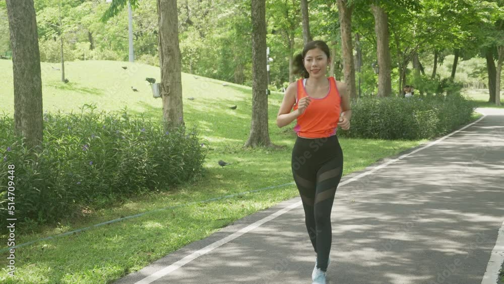 Beautiful young asian woman workout with jogging or running on summer in the park, girl exercise for relax with sport on tropical in the garden, one person, health care and sportive concept. Beautiful young asian woman workout with jogging or running on summer in the park, girl exercise for relax with sport on tropical in the garden, one person, health care and sportive concept.