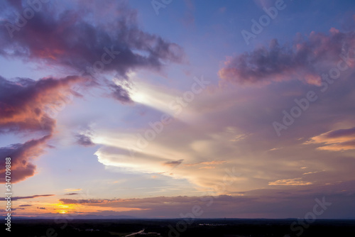 Dramatic orange sunset with the sun peeking through the clouds an gorgeous panorama view