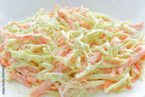 Creamy coleslaw salad with carrot, and cabbage on a white plate. photo