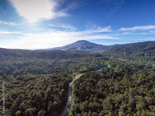 Talang volcano from forest of sitinjau laut at solok regency west sumatra in sunny day and blue sky photo