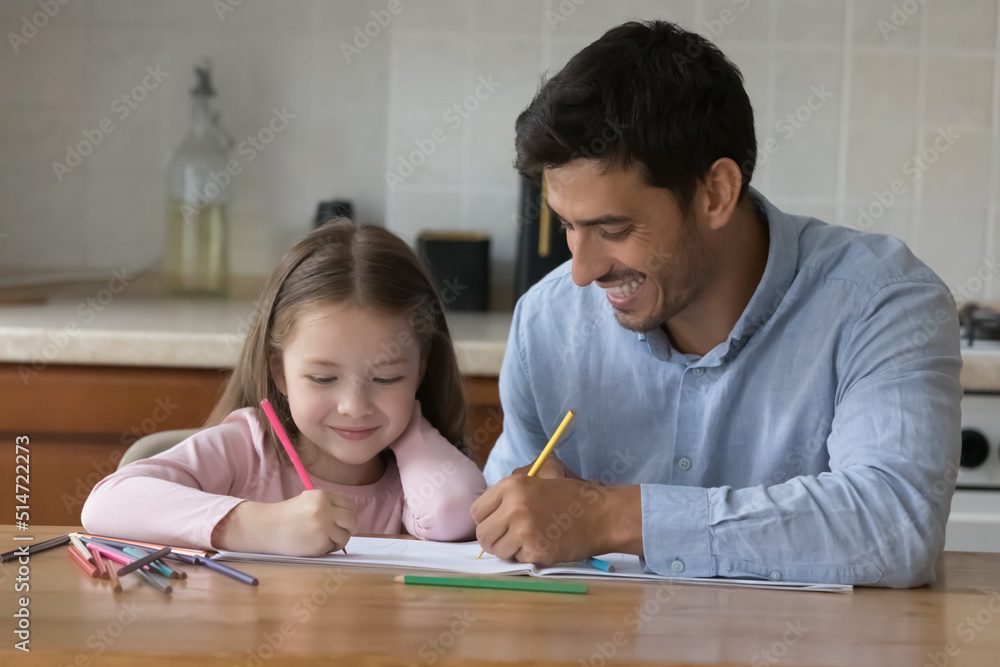 Hispanic loving stepdad drawing pictures on album with preschool daughter, spend weekend leisure together at home, enjoy hobby sit at table in kitchen. Class of painting, fun, creative pastime concept Hispanic loving stepdad drawing pictures on album with preschool daughter, spend weekend leisure together at home, enjoy hobby sit at table in kitchen. Class of painting, fun, creative pastime concept
