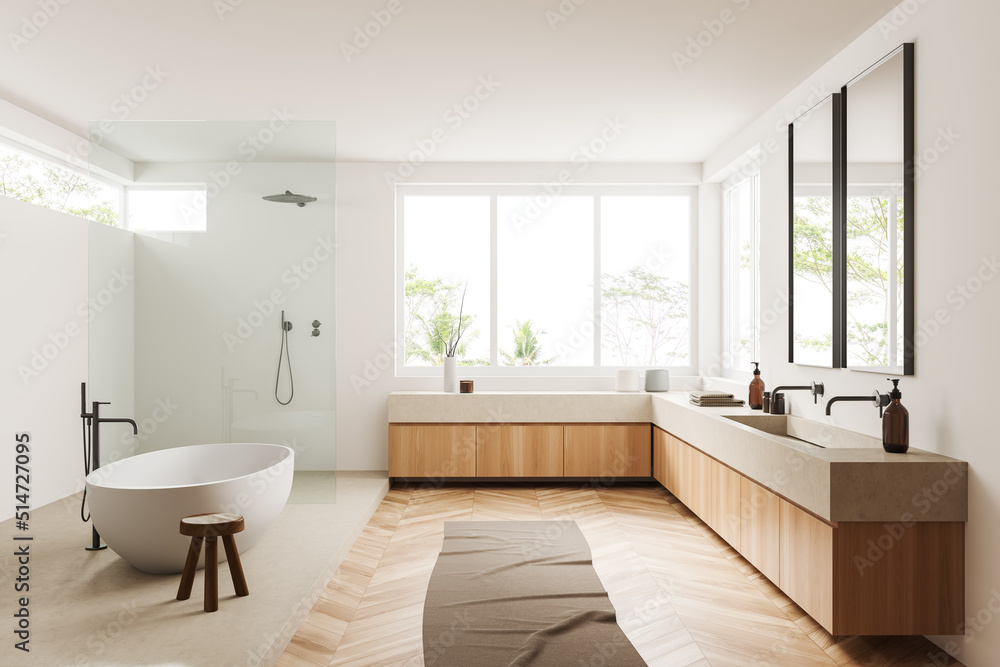 Light bathroom interior with bathtub, shower, sink and panoramic window