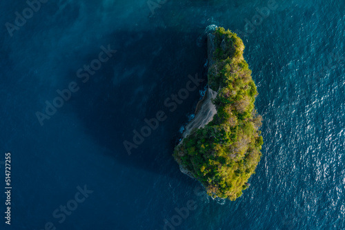 Aerial drone top view shot of rocky beach with cliff. Indian ocean shore. Copy space for text. Nature and travel background. Beautiful natural summer vacation travel concept. Waves splash.