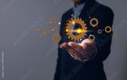 business man with hands and gears on palm industrial concept
