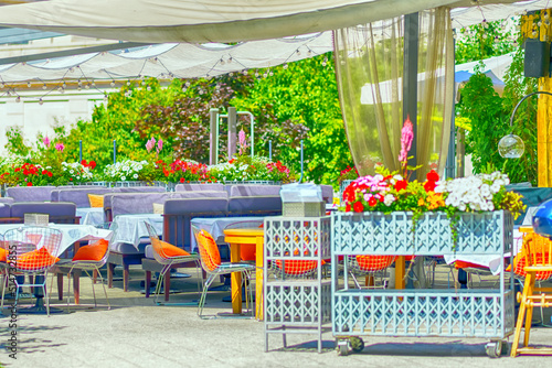 Fototapeta Naklejka Na Ścianę i Meble -  Empty street cafe on a bright sunny day