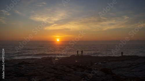 Early morning sunrise on the south coast of South Africa in Margate with people catching fish