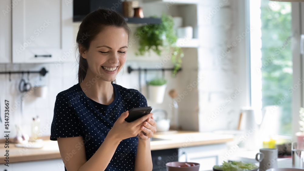 Cheerful happy smartphone user girl watching online media funny content, video recipe for cooking salad, talking on conference call, smiling, laughing on mobile phone screen. Banner shot Cheerful happy smartphone user girl watching online media funny content, video recipe for cooking salad, talking on conference call, smiling, laughing on mobile phone screen. Banner shot