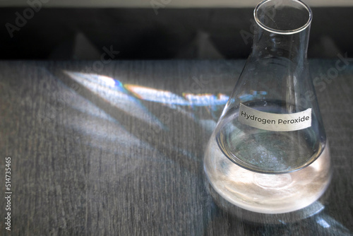 Hydrogen Peroxide in a glass flask - top view. The concept of the chemical reagent Hydrogen Peroxide. horizontal photo