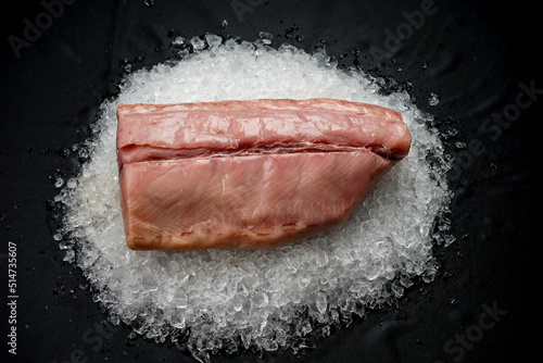 large fresh fish fillet on ice