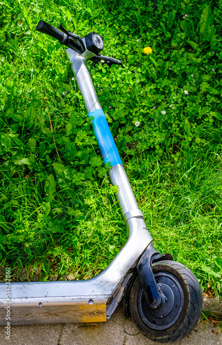 modern eScooter lying at a meadow photo