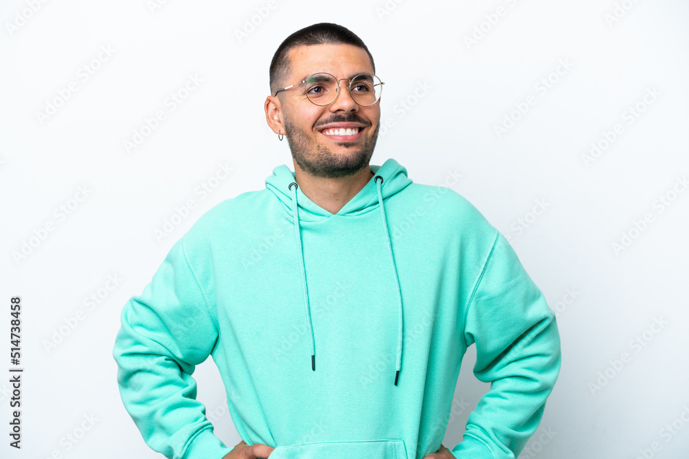 Young caucasian man isolated on white background posing with arms at hip and smiling Young caucasian man isolated on white background posing with arms at hip and smiling