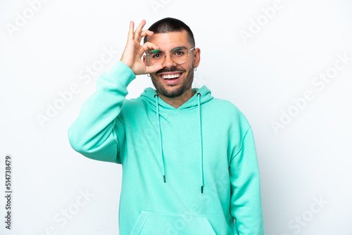 Young caucasian man isolated on white background showing ok sign with fingers © luismolinero