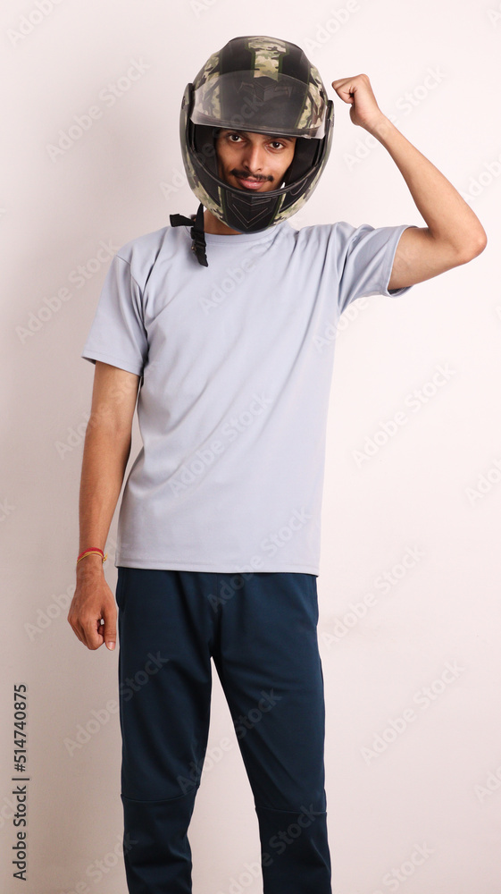 Indian collage boy wears black helmet or head protection gear for safety on white background with different expressions also person pointing by hand to helmet copy space proud and confident Indian collage boy wears black helmet or head protection gear for safety on white background with different expressions also person pointing by hand to helmet copy space proud and confident