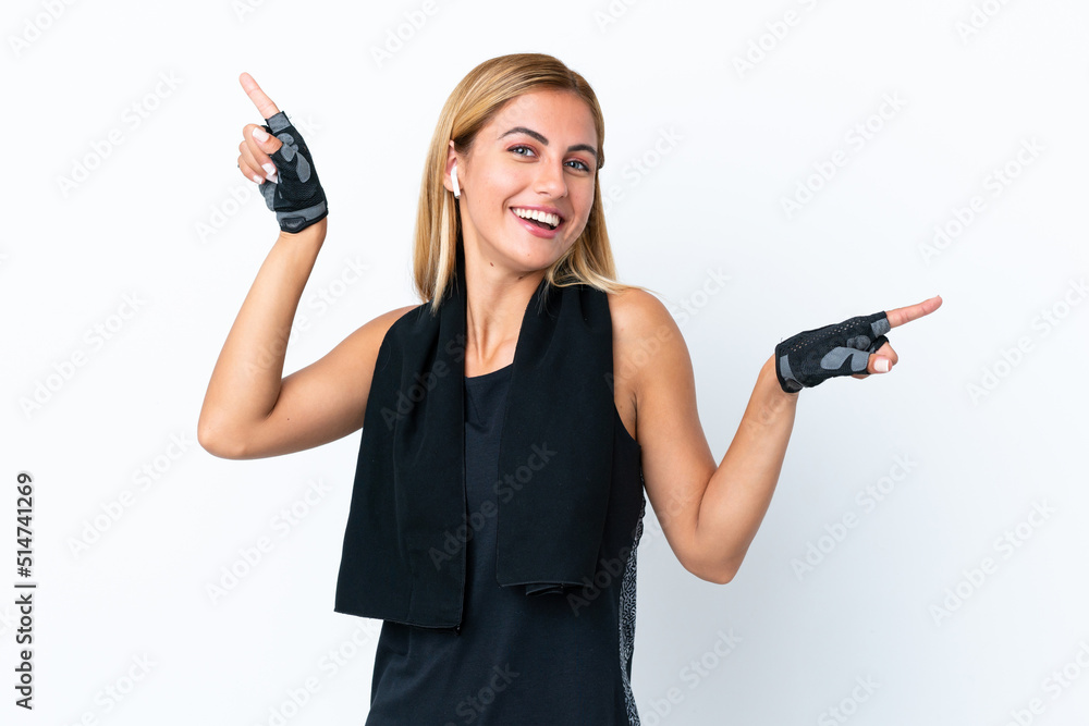 Blonde Uruguayan sport girl isolated on white background pointing finger to the laterals and happy Blonde Uruguayan sport girl isolated on white background pointing finger to the laterals and happy