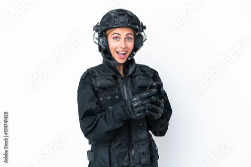 SWAT caucasian woman isolated on white background surprised and sending a message