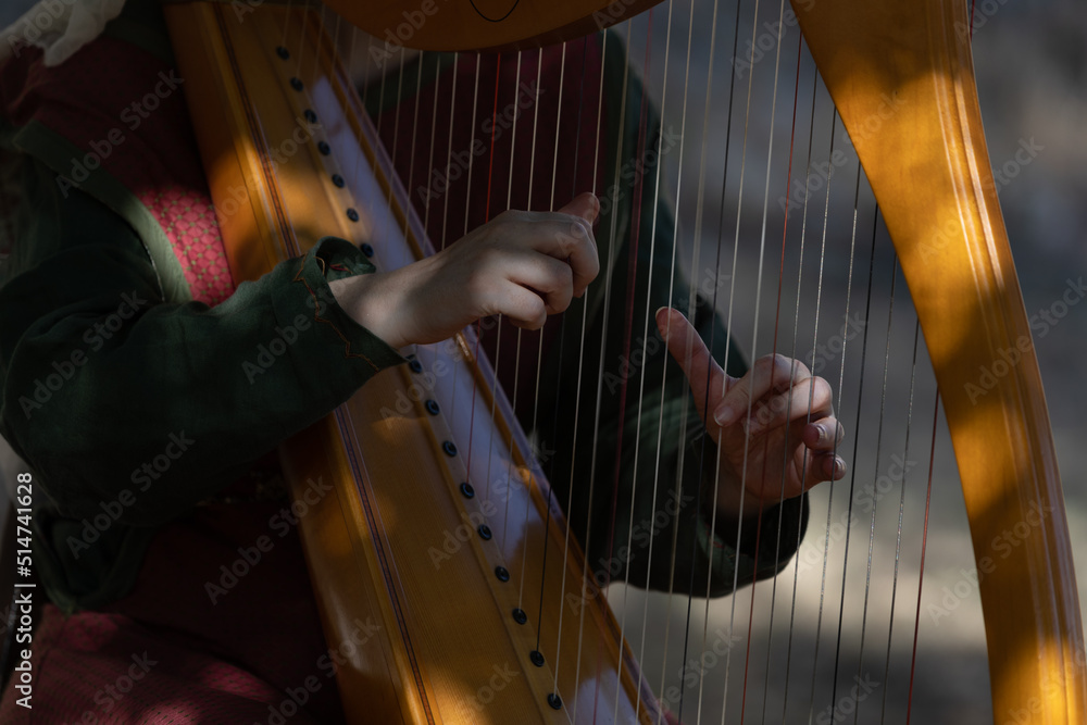 hand plucking the harp strings
