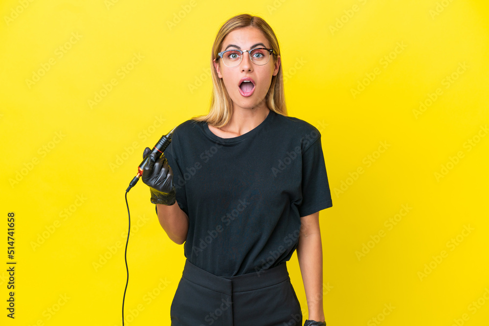 Tattoo artist Uruguayan woman isolated on yellow background with surprise facial expression