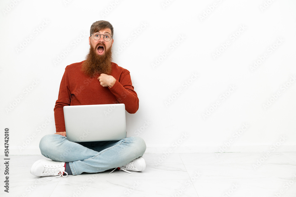 Young reddish caucasian man with laptop isolated on white background with surprise facial expression Young reddish caucasian man with laptop isolated on white background with surprise facial expression