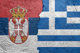 Serbia and Greece - Cracked concrete wall painted with a Serbian flag on the left and a Greek flag on the right stock photo