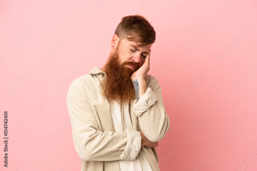 Young reddish caucasian man isolated on pink background with headache Young reddish caucasian man isolated on pink background with headache