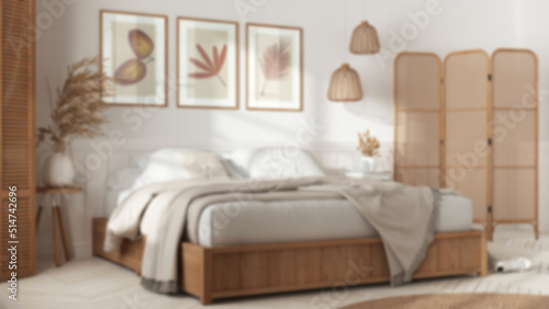 Blurred background, wooden scandinavian bedroom. Double bed with blankets. Wall panel and parquet floor, carpet.Rattan folding screen and lamps. Interior design