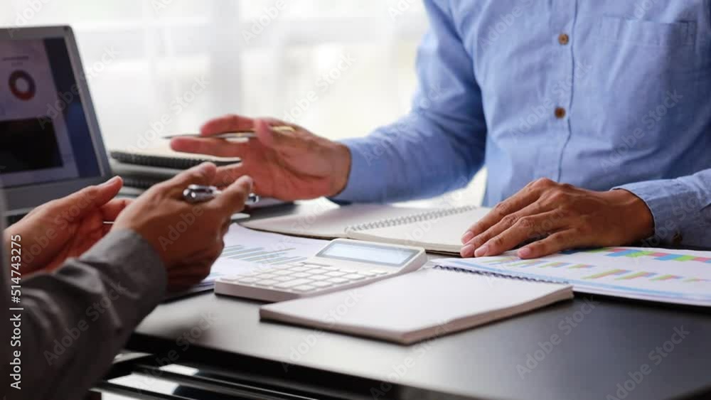 Two businessmen are meeting together in the company conference room, discussing plans to grow the business and meet business plans and business solutions. Business meeting idea. Two businessmen are meeting together in the company conference room, discussing plans to grow the business and meet business plans and business solutions. Business meeting idea.
