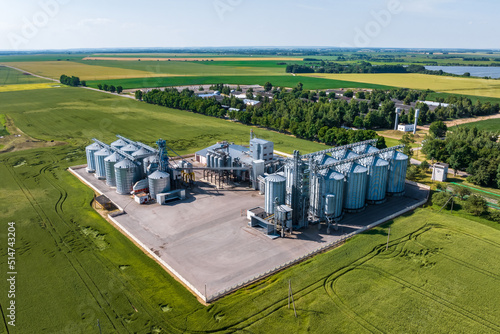 aerial view on agro silos granary elevator on agro-processing manufacturing plant for processing drying cleaning and storage of agricultural products, flour, cereals and grain. © hiv360