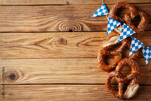 Fototapeta Oktoberfest concept with pretzel and blue simbol flag on wood background