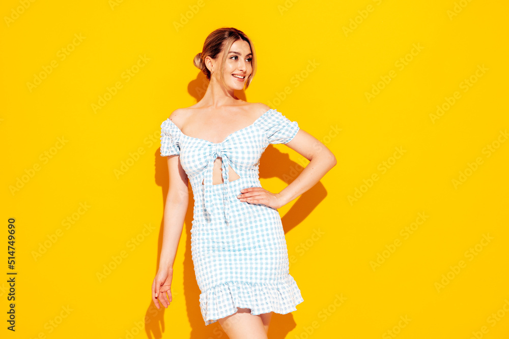 Young beautiful smiling female in trendy summer shorts and top clothes. Sexy carefree woman posing near yellow wall in studio. Positive model having fun. Cheerful and happy Young beautiful smiling female in trendy summer shorts and top clothes. Sexy carefree woman posing near yellow wall in studio. Positive model having fun. Cheerful and happy