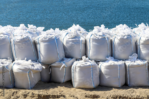 Large sandbags by the sea to prevent flooding photo