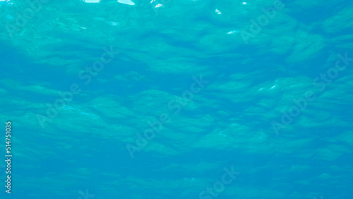 Surface of the sea. Natural background with sun glints on surface of the water. Underwater view. Red sea, Egypt