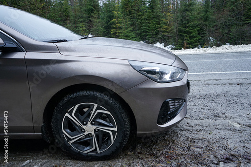 Car on a winter road in the forest. Road Trip Concept