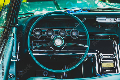 retro car dashboard interior. View of the steering wheel and dashboard of an old vintag car.
