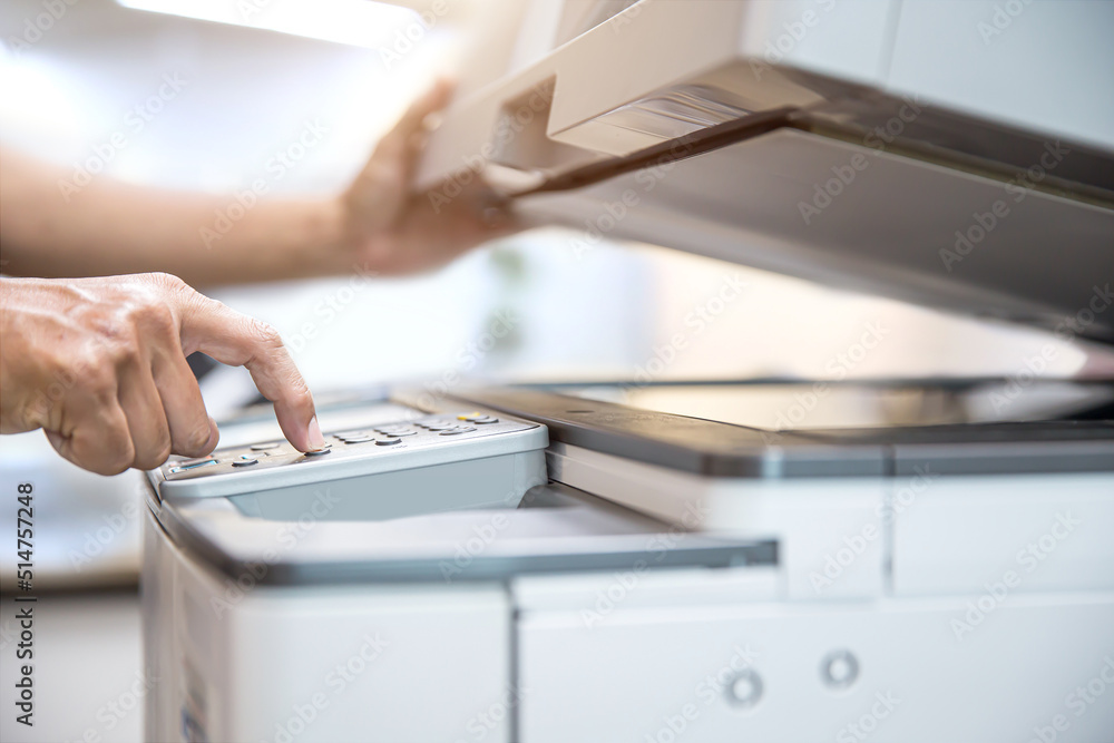 Photocopier printer, Close up hand office man press copy button on panel to using the copier or photocopy machine for scanning document or printing paper or Xerox a sheet. Photocopier printer, Close up hand office man press copy button on panel to using the copier or photocopy machine for scanning document or printing paper or Xerox a sheet.