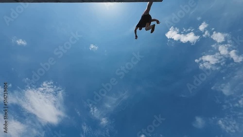 Man jumps into the water on a summer sunny day photo