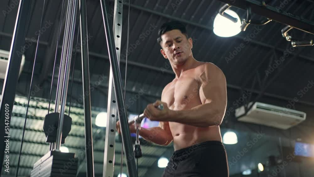4K Caucasian sportsman in sportswear do sport workout exercise pulling weight lifting machine at gym. Active man bodybuilder athlete practicing muscular bodybuilding weight training at fitness club 4K Caucasian sportsman in sportswear do sport workout exercise pulling weight lifting machine at gym. Active man bodybuilder athlete practicing muscular bodybuilding weight training at fitness club