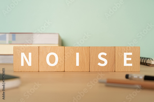 騒音・ノイズのイメージ｜「NOISE」と書かれたブロックが置かれたデスク