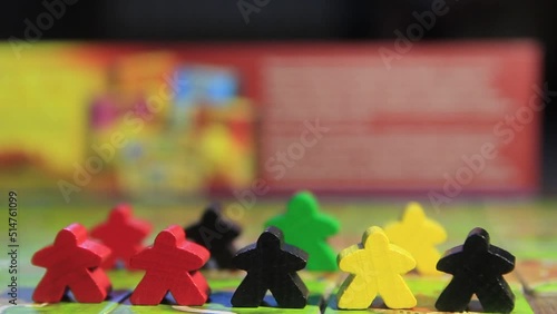 Board game carcasson with tiles and wooden playing pieces close-up. photo