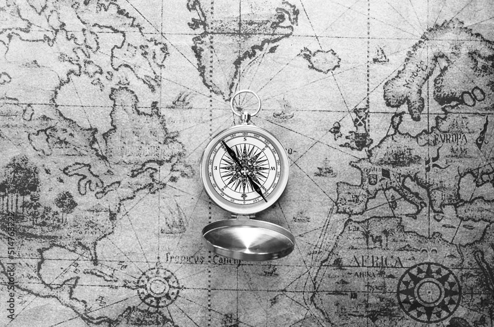 Classic round compass on background of old vintage map of world as ...