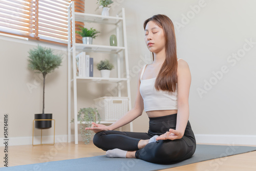 Routine health wellbeing concept. Woman doing meditation at home for practice her mindfulness pose lotus hand and breathing care. © Pormezz