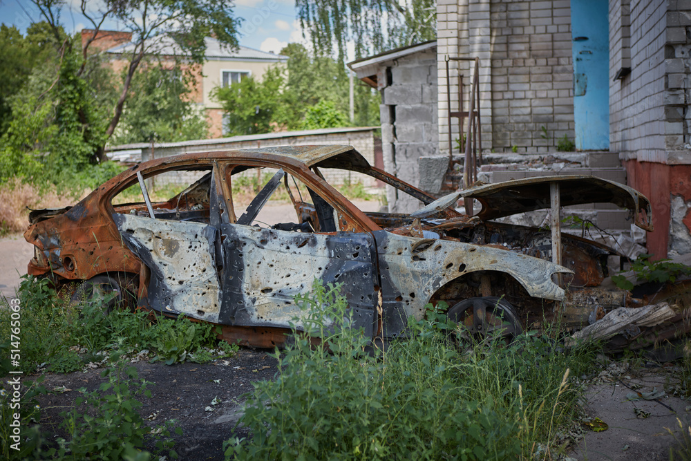 Destroyed car on the street as a result of the attack of Russian invaders