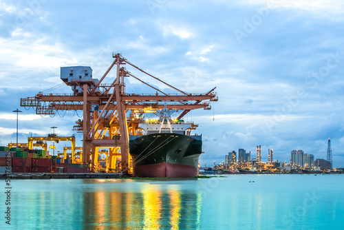 Photography Industrial Container Cargo freight ship with working crane bridge in shipyard at