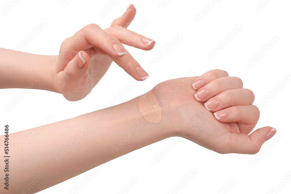 Swatch of foundation on a woman hand isolated on white background.