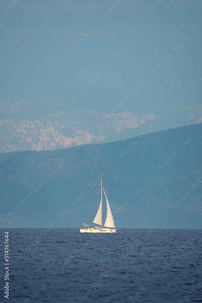 Seascape with white sailboat in blue see