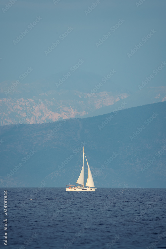Fototapeta premium Seascape with white sailboat in blue see