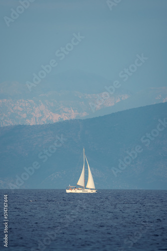 Seascape with white sailboat in blue see