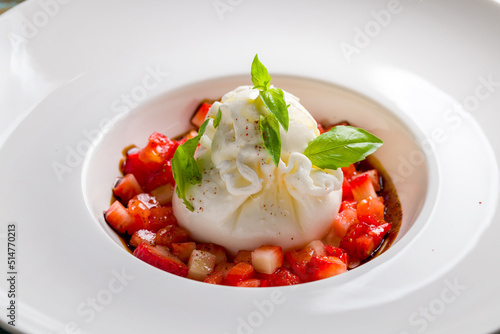 salad with buratta cheese and strawberries with basil macro close up