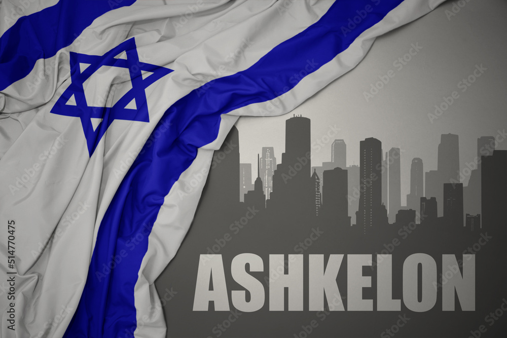 abstract silhouette of the city with text Ashkelon near waving national flag of israel on a gray background.3D illustration