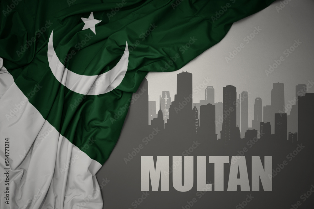 abstract silhouette of the city with text Multan near waving national flag of pakistan on a gray background.3D illustration