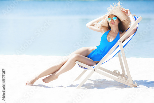 Attractive young woman on the beach. Sexy young lady on the sea shore.Female relaxing on resort. Model on seaside.